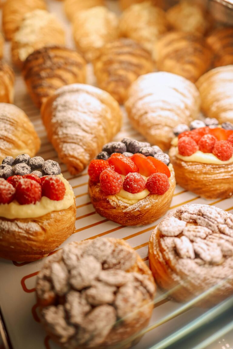 Tantalizing display of assorted pastries with fresh fruit toppings and powdered sugar.